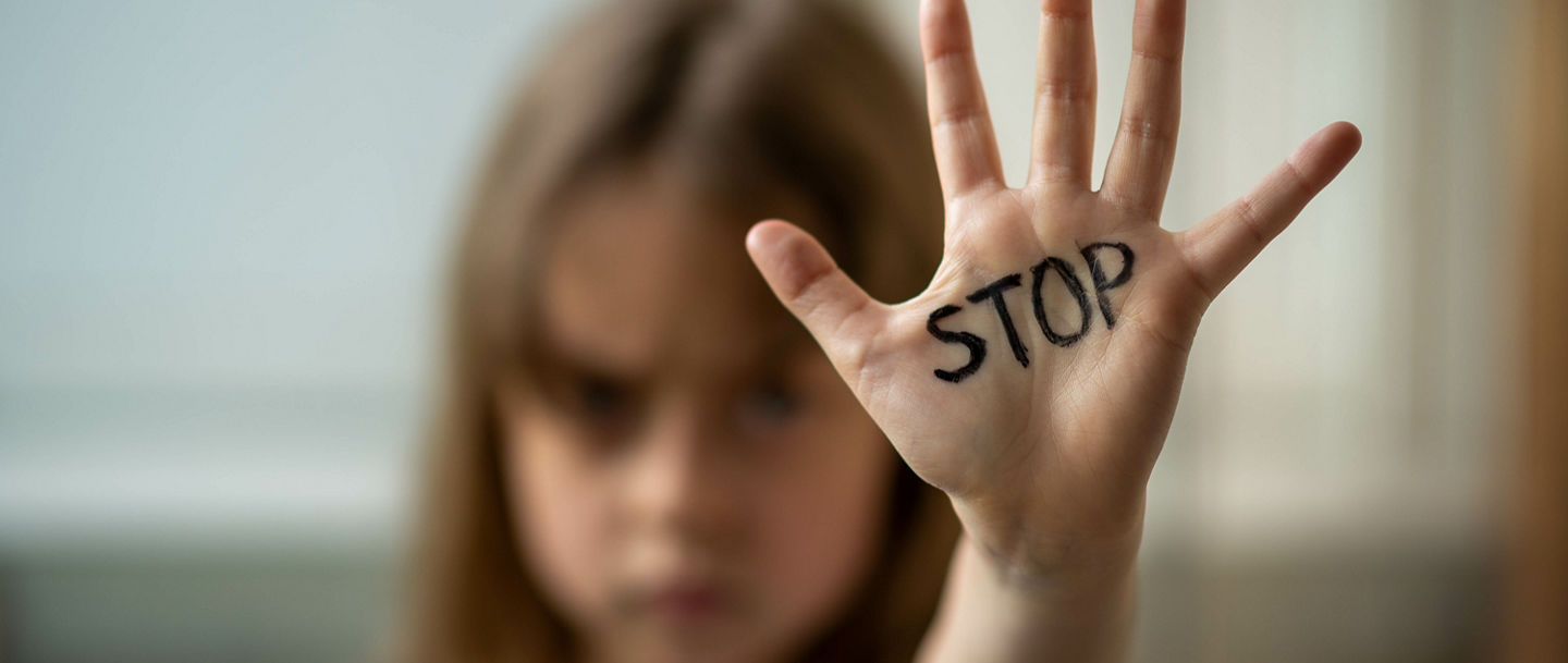 The child makes a stop gesture with his hand. Stop domestic and child abuse. Protecting the rights of children.