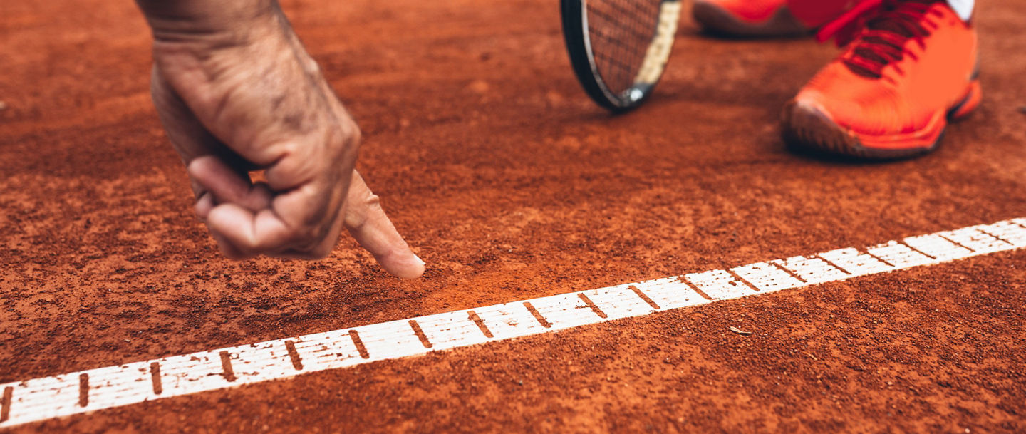 close up of referee showing that the ball was out on tennis court