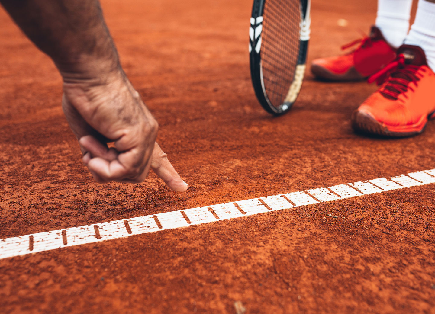 close up of referee showing that the ball was out on tennis court