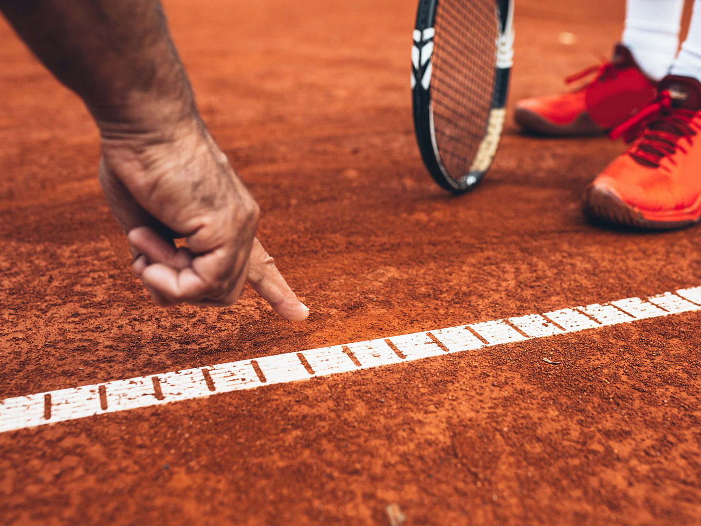 close up of referee showing that the ball was out on tennis court