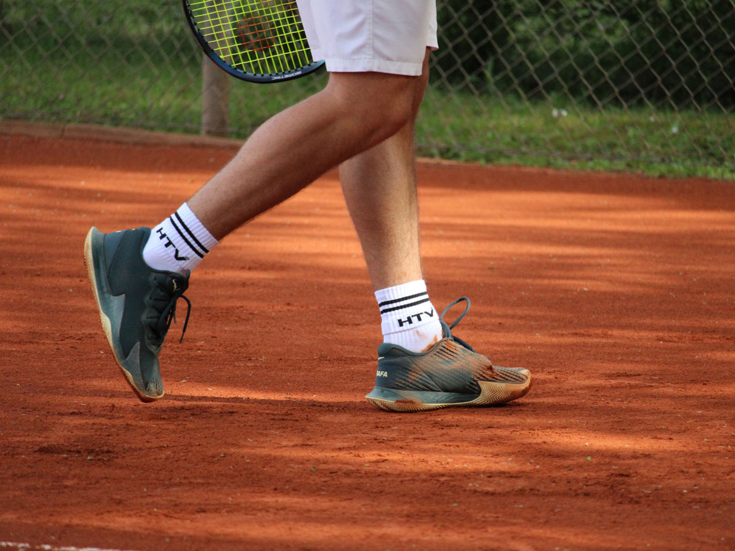 Tennis player on clay court in action