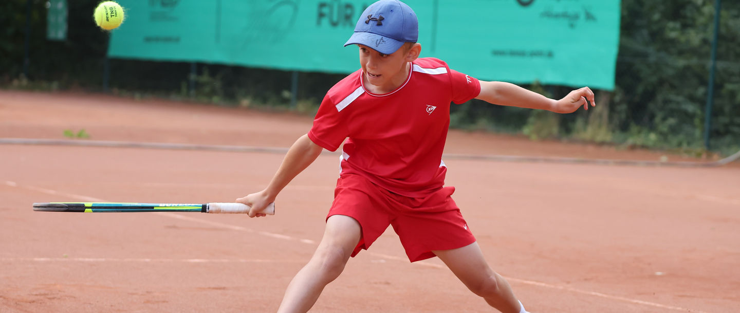 Junge spielt Tennis