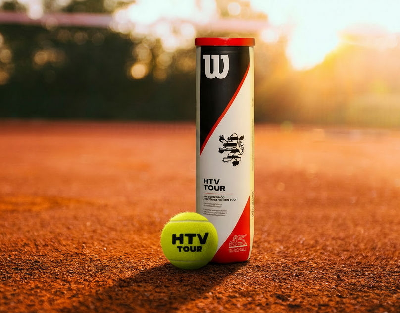 Tennis ball and can on clay court