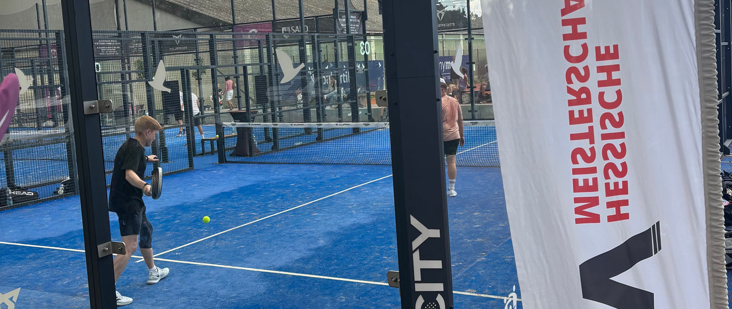 Padel court with players and banners