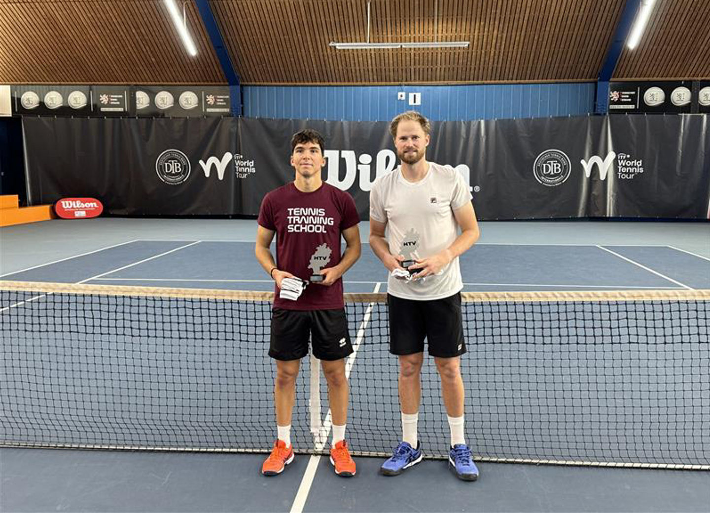Indoor tennis court with two players