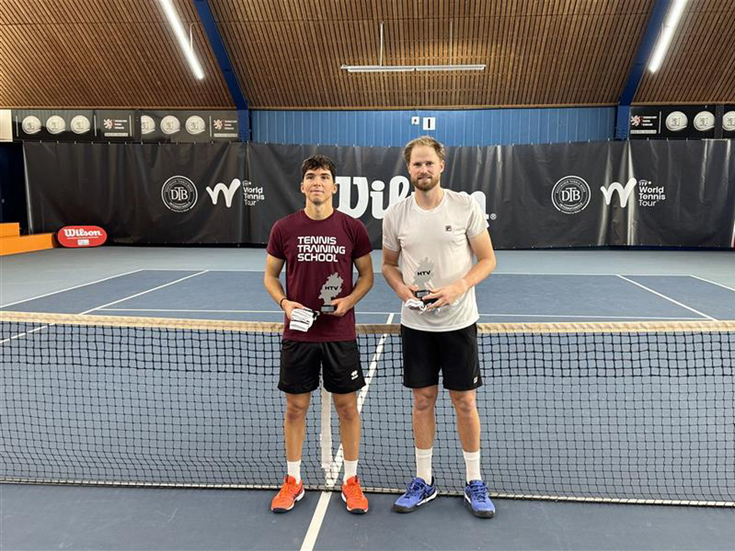 Indoor tennis court with two players