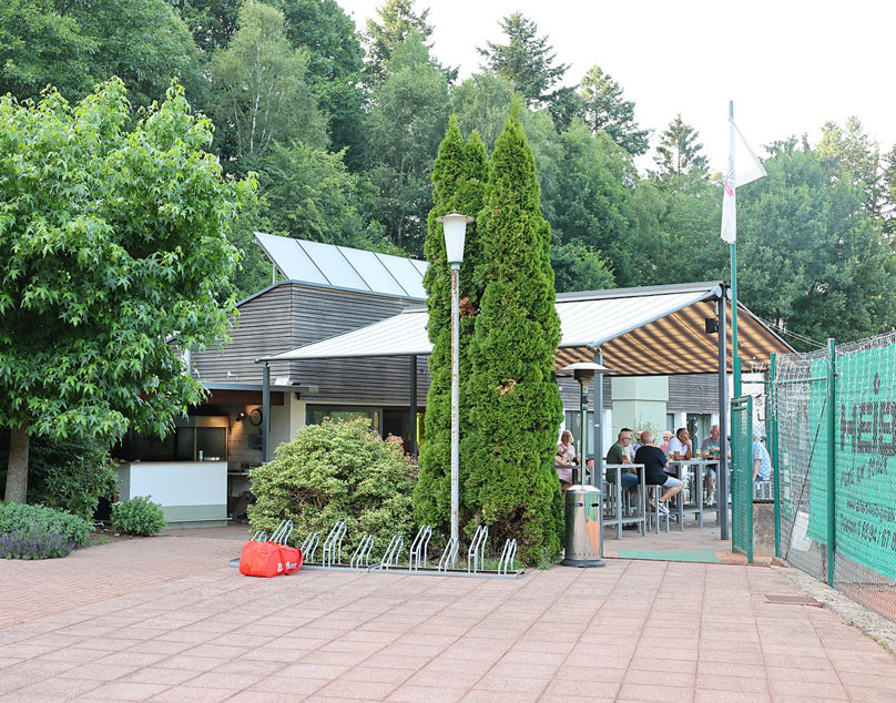 Blick auf ein Vereinsheim, umgeben von Wald
