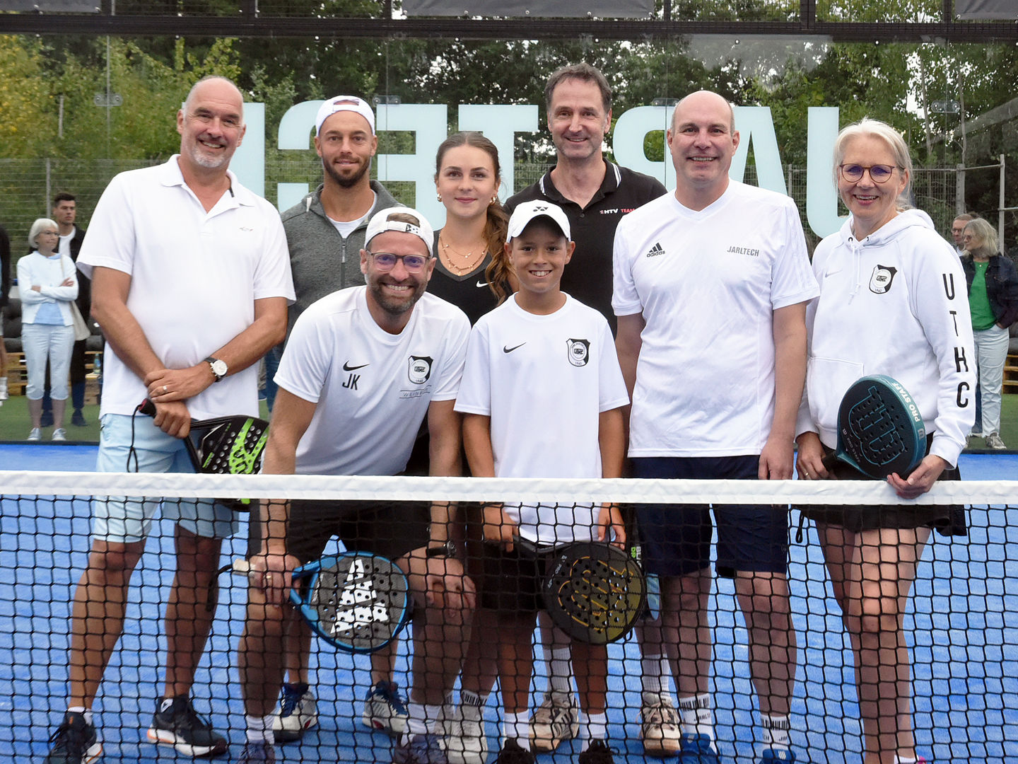 Group of paddle tennis players on court