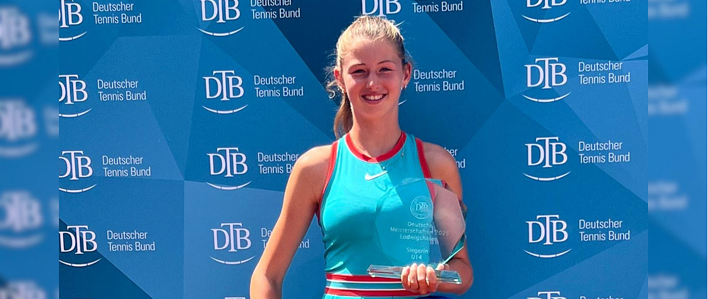 Lilly Marie Greinert mit Trophäe vor der Pressewand des DTB