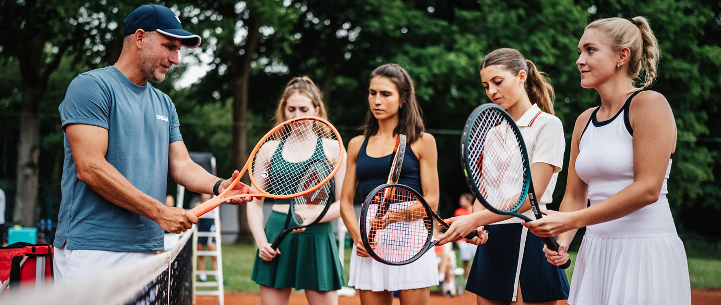 Tennistrainer mit Spielerinnen