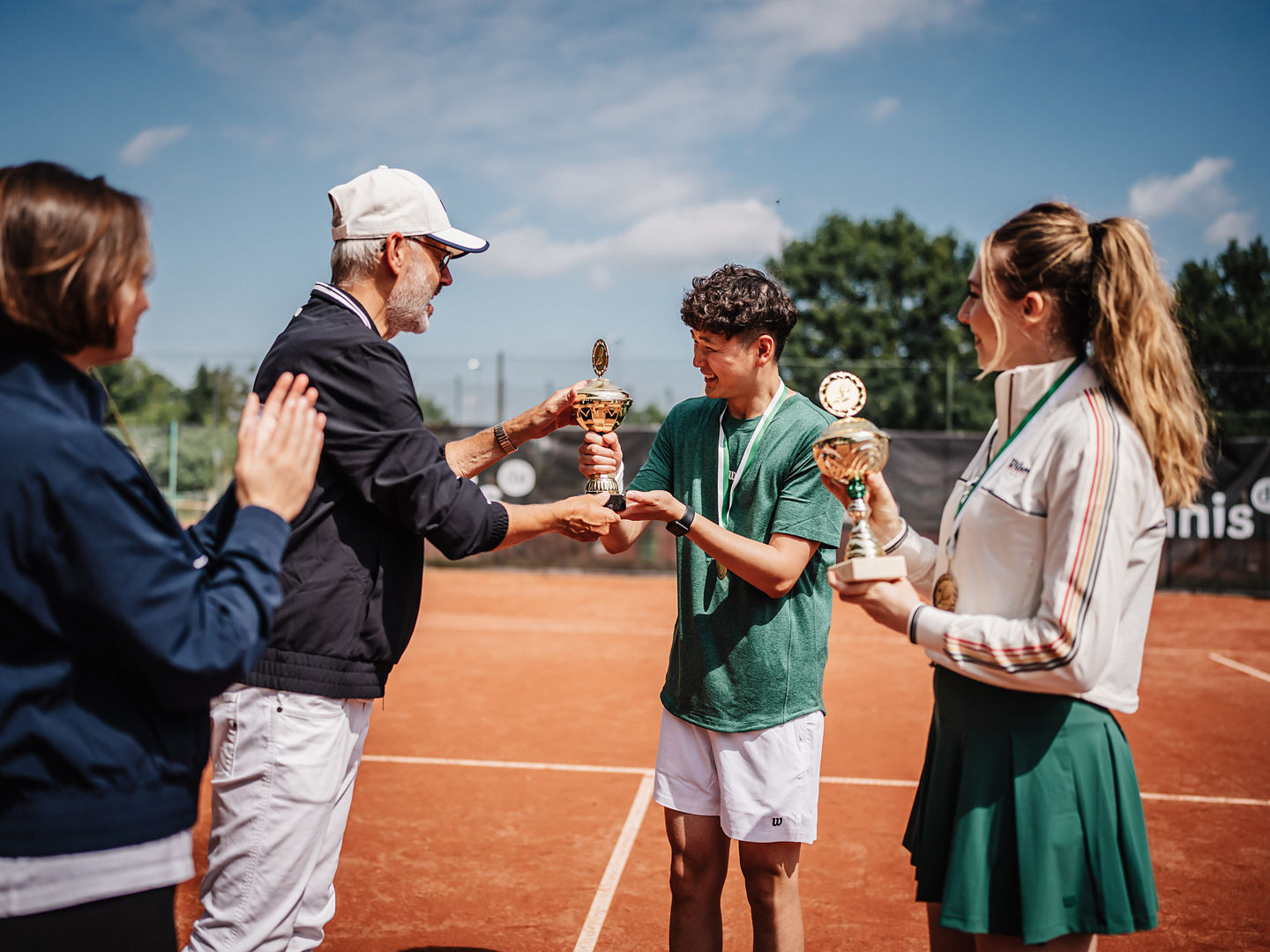 Zwei Spieler:innen bekommen einen Pokal