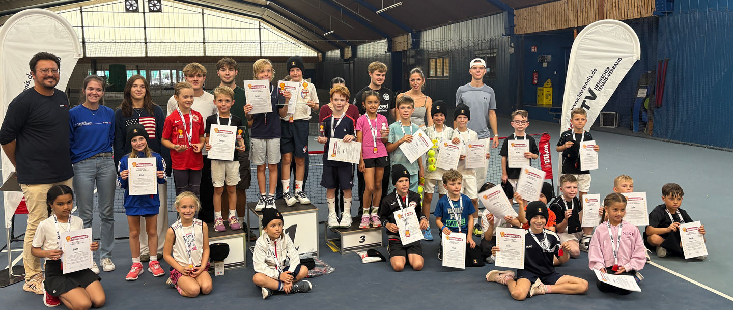 Group of young tennis players with awards