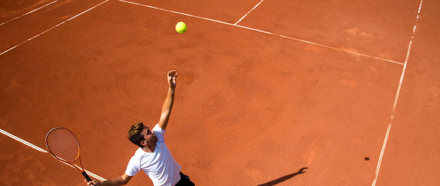 Young man playing tennisYoung man playing tennis