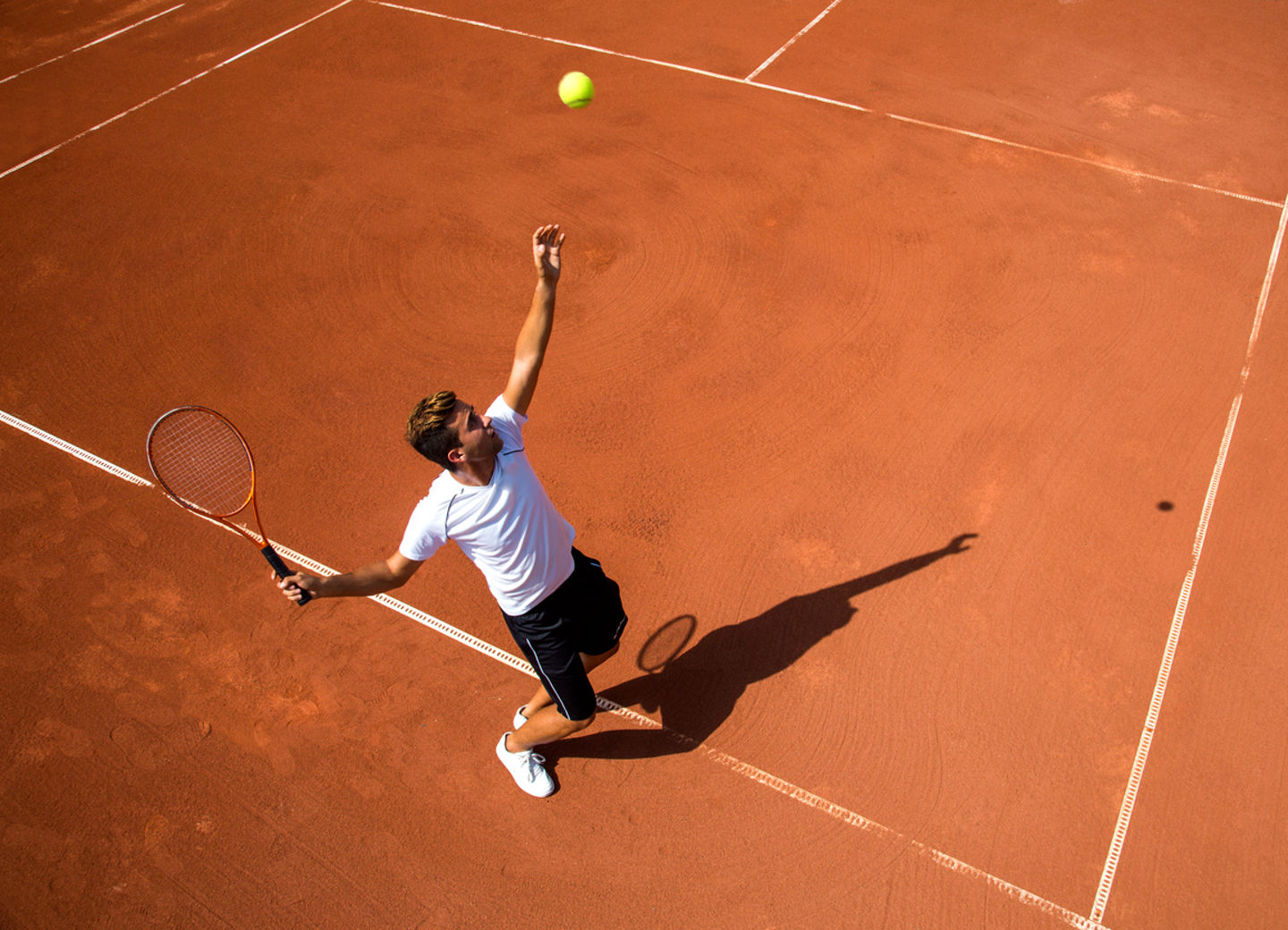 Young man playing tennisYoung man playing tennis