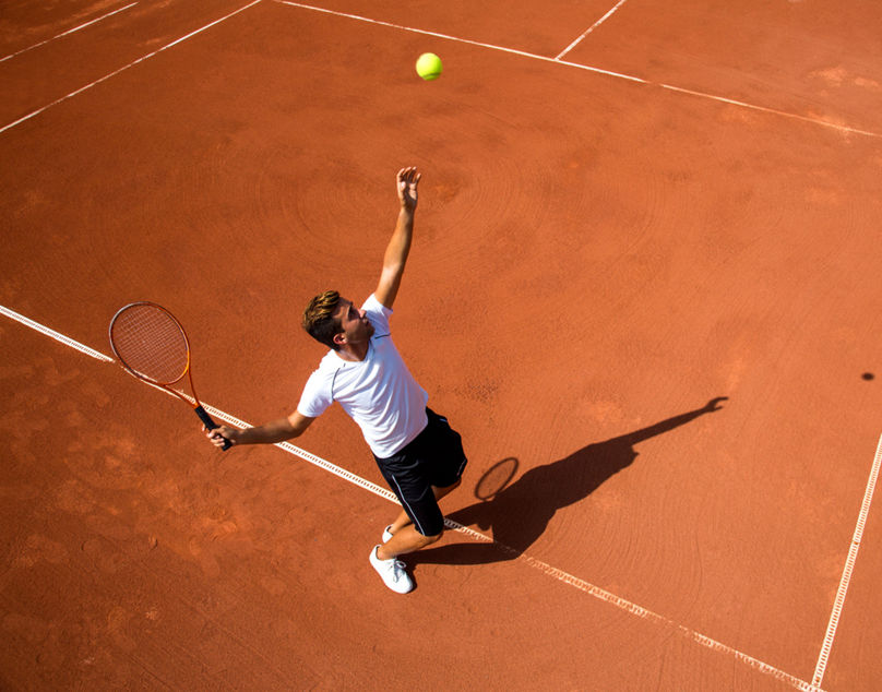 Young man playing tennisYoung man playing tennis