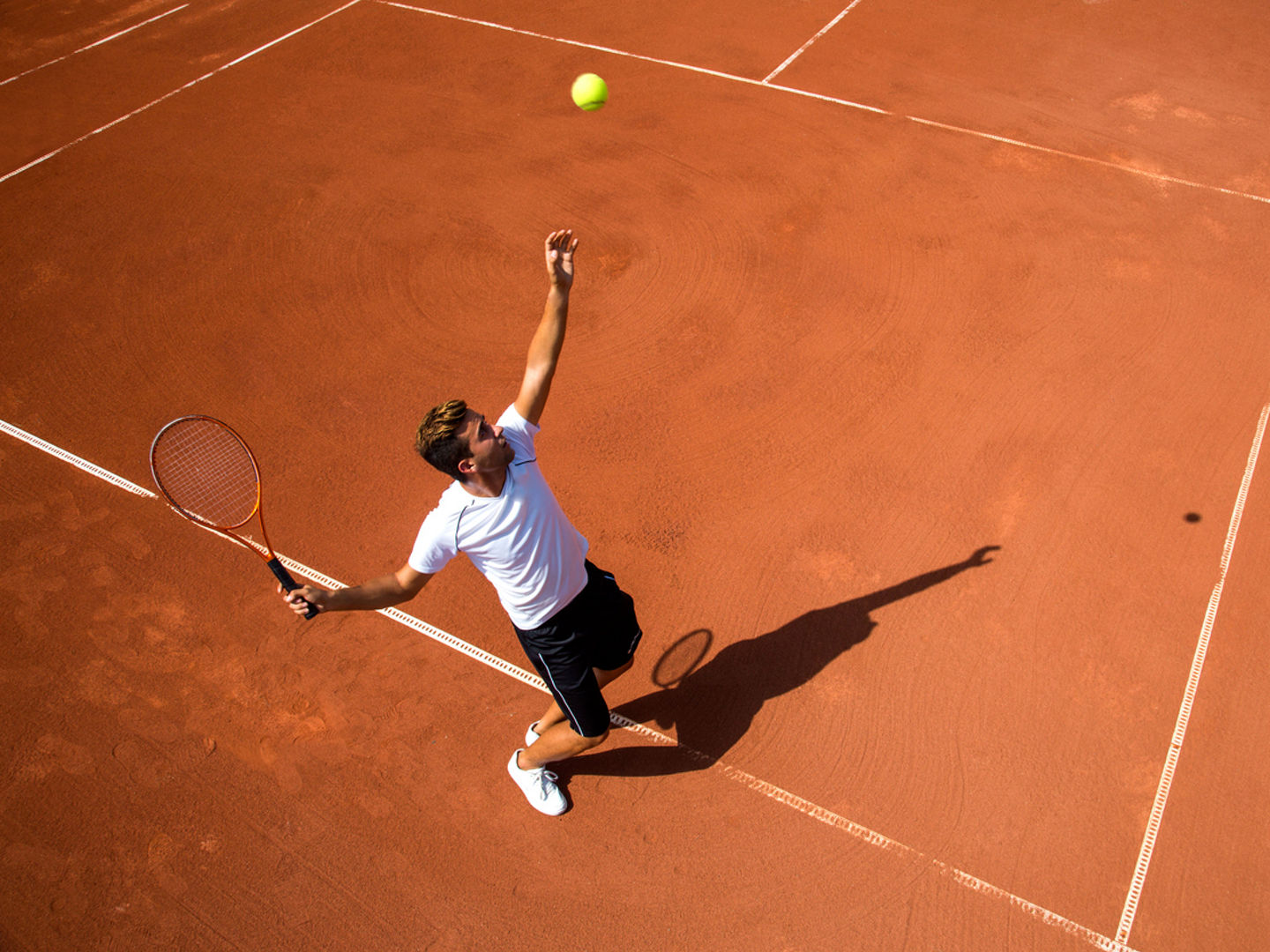 Young man playing tennisYoung man playing tennis
