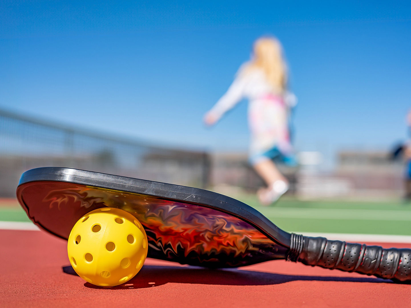 selective focus on a pickleball and paddle on the court surface. selective focus on a pickleball and paddle on the court surface. . High quality photo LicenseRF 21994278 Copyright: xZoonar.com/STEVENxWHITEx 21994278