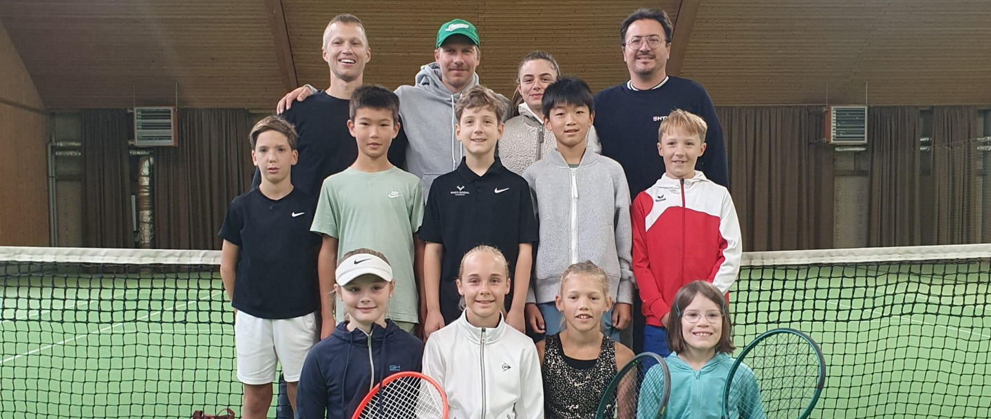 Group of tennis players indoors on court
